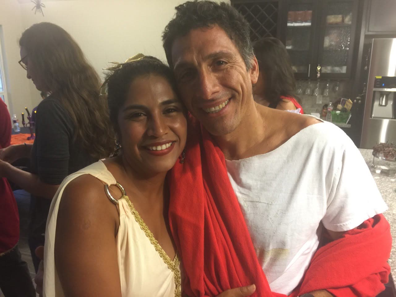 A smiling couple in costume at a church party